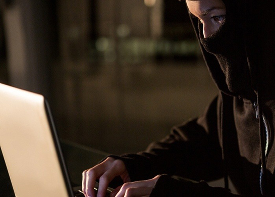 Woman in balaclava using laptop in the office-235961-edited.jpeg Featured Image